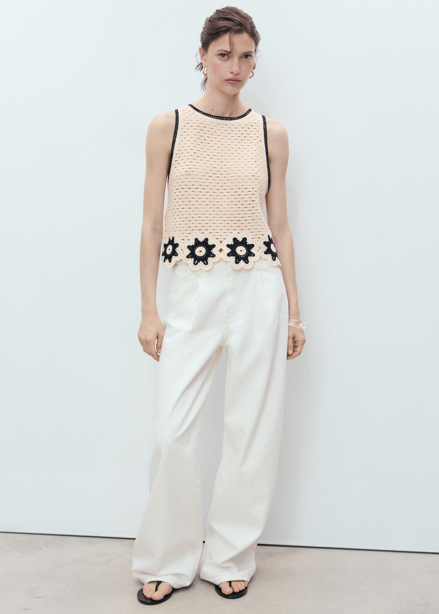 Crochet top with floral finishes