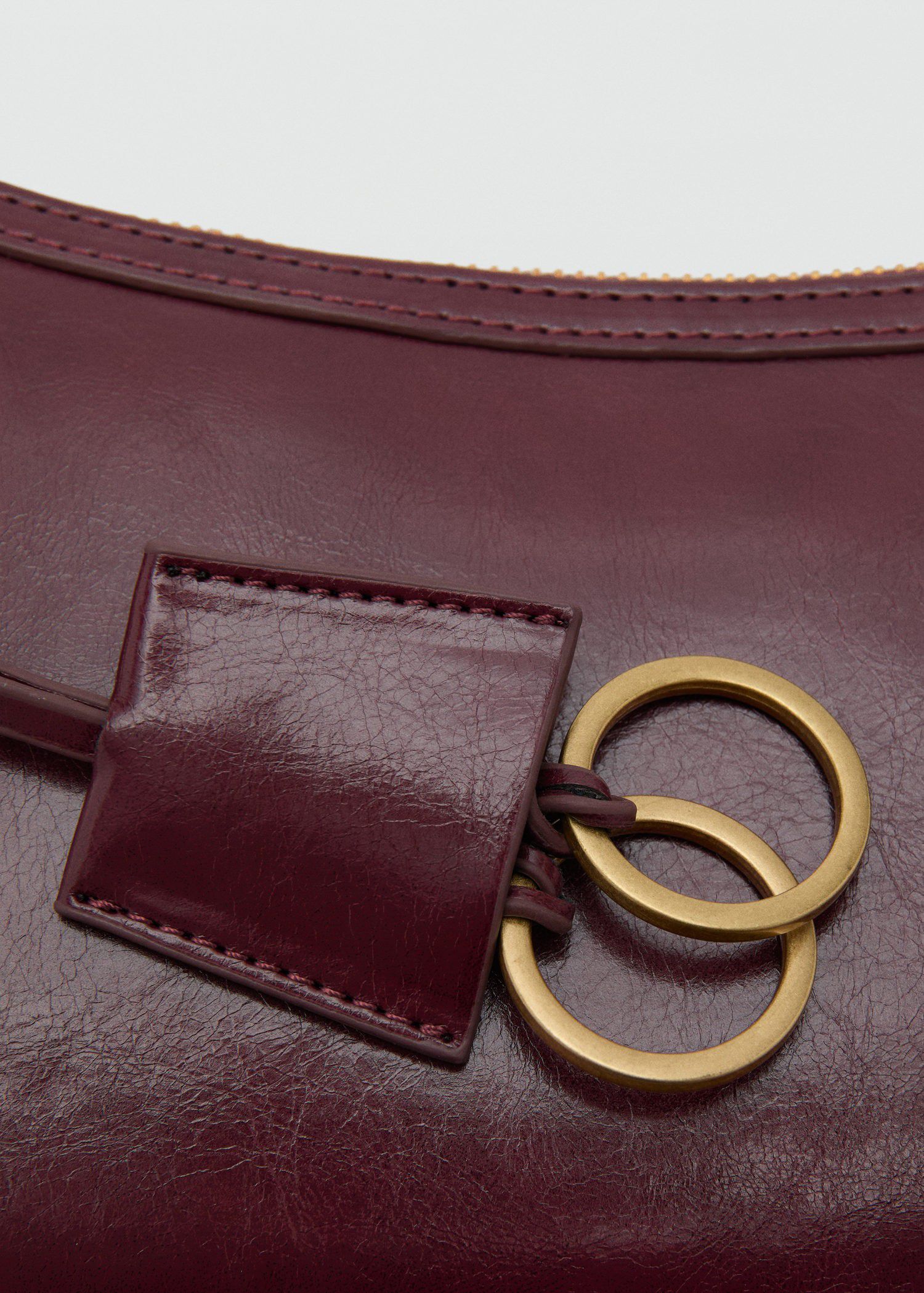 Crossbody bag with charms and rings