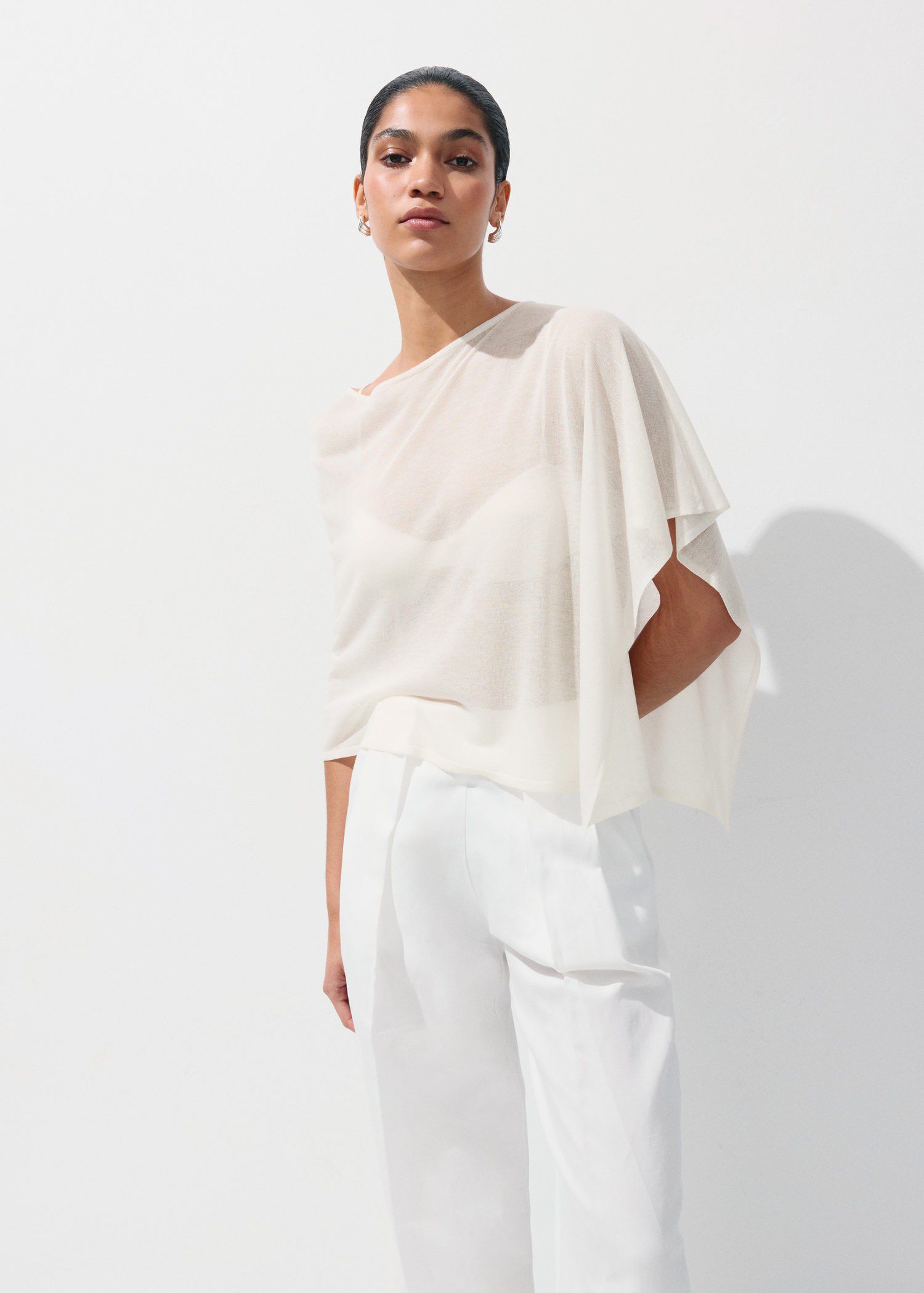 Asymmetrical knitted cape