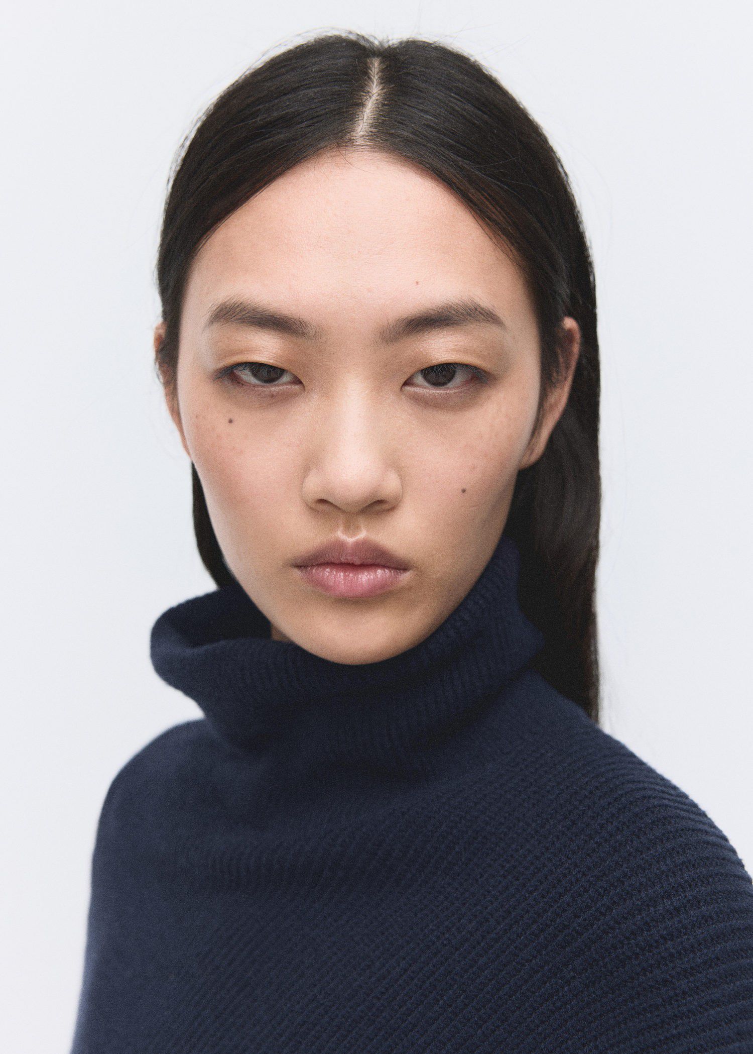 Sweater with asymmetrical roll neck