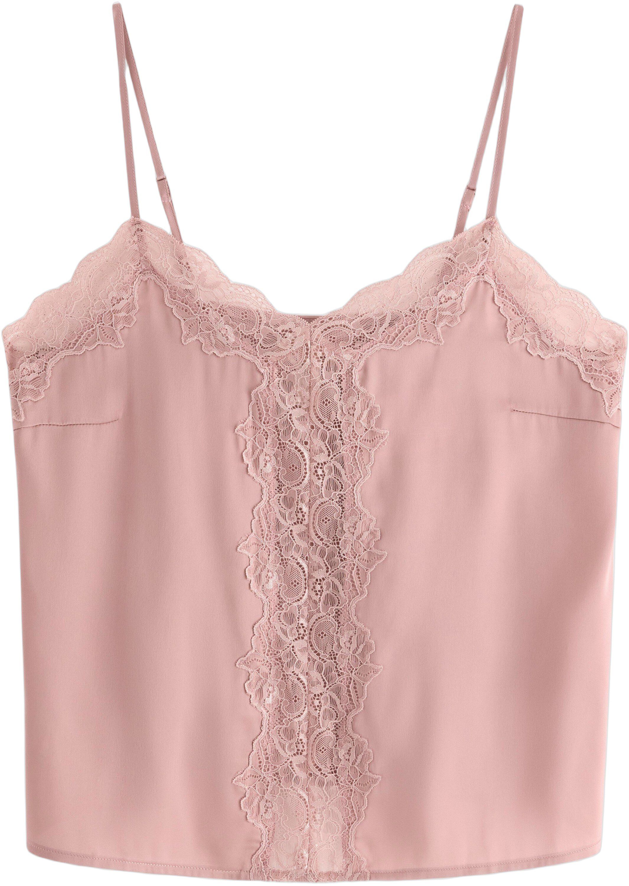 Linne i satin med spetsdetaljer.